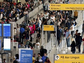 People wait in a TSA line at the John F. Kennedy International Airport on June 28, 2022, in New York.