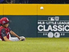 Canadian left fielder Omar Bosmina and his teammates went down during the Little League World Series tournament in South Williamsport, Pennsylvania.