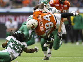 Manny Arceneaux is upended by Saskatchewan Roughriders #35 Weldon Brown in a regular season CFL football game at BC Place on July 10, 2015.