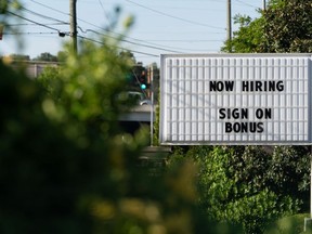 A "Now Hiring" sign outside a business in Lithonia, Georgia, U.S.