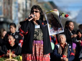 Sheridan Martin holds a photograph of Cindy Martin during the 29th annual Women's Memorial March, an annual event to honour the lives of missing and murdered women, in Vancouver on Feb. 14, 2020.