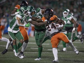 Running back James Butler, who returns to the Lions' lineup after missing last weekend’s game, gives Riders linebacker Darnell Sankey a stiff arm during last month’s game at Mosaic Stadium.