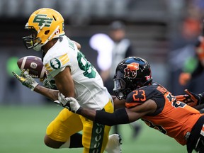 Edmonton Elks' Kenny Lawler, left, fumbles the ball on a kick return and turns it over as BC Lions' Delvin Breaux Sr.  tackles him during the first half of the CFL football game in Vancouver, on Saturday, Aug.  6, 2022.