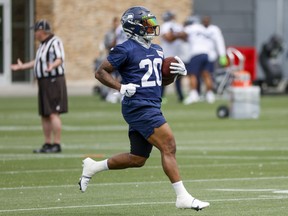 Seattle Seahawks running back Rashaad Penny (20) rushes a drill during minicamp practice at the Virginia Mason Athletic Center Field. Photo: Joe Nicholson-USA TODAY Sports