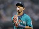 Seattle Mariners' Julio Rodriguez blows a bubble as he runs to the dugout while leaving the field during the second inning of a baseball game against the Cleveland Guardians, Friday, Aug. 26, 2022, in Seattle.