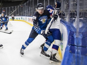 Finland's Joni Jurmo (4) checks Slovakia's Roman Faith (9) during third period IIHF World Junior Hockey Championship action in Edmonton on Sunday August 14, 2022.