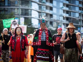 Wet'suwet'en hereditary Chief Namoks (John Ridsdale), centre, leads a protest march in Vancouver against the Coastal GasLink pipeline project on Aug. 15, 2022.