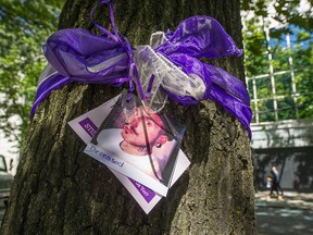 Members of Moms Stop the Harm tied purple sashes with photos of their deceased loved ones along Robson Street in their memory on Tuesday, as the B.C. Coroners Service said over 10,000 lives have been lost during the overdose epidemic in B.C. since 2016.