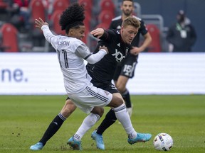 Former D.C. United defender Julian Gressel (31) fouls Toronto FC forward Jayden Nelson (11) during first half MLS in Toronto on March 19, 2022. The Vancouver Whitecaps obtained the wingback from DC United in a late July trade. The Whitecaps will be looking to climb back over the playoff line again when they host Nashville FC Saturday night at BC Place Stadium.