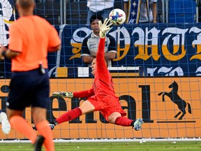 Aug 13, 2022; Carson, California, USA;   A kick by Los Angeles Galaxy midfielder Samuel Grandsir (11) gets past Vancouver Whitecaps goalkeeper Cody Cropper (55) for a goal in the first half at Dignity Health Sports Park.