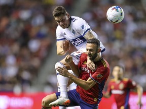Vancouver Whitecaps FC defender Jake Nerwinski (28) and Real Salt Lake forward Justin Meram (9) battle for a head ball in the first half at Rio Tinto Stadium Aug. 20, 2022.