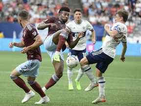 Vancouver Whitecaps FC midfielder Ryan Gauld (25) battles for the ball against the Colorado Rapids during the first half at BC Place Aug. 17, 2022.