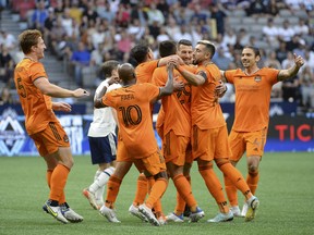 The Houston Dynamo celebrate midfielder Fafa Picault (10)'s goal in the first half against the Vancouver Whitecaps at BC Place. Photo: Anne-Marie Sorvin-USA Today Sports