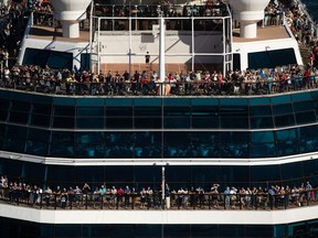 People stand on decks at the bow of the Celebrity Cruises vessel Celebrity Eclipse as it leaves port in Vancouver for a trip to Alaska, on Sunday, Aug. 14, 2022.