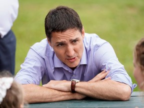 Prime Minister Justin Trudeau speaks with families during a visit in Stratford, PEI, July 22, 2022.