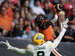 Lions receiver Dominique Rhymes hauling in one of his three touchdown receptions against Raphael Leonard and the visiting Edmonton Elks on Saturday.