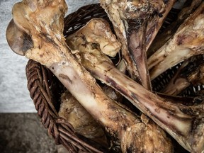 File photo of a basket full of cooked bones.  A Vancouver couple say they faced a huge vet bill after their dog ate cooked pork shank bone.