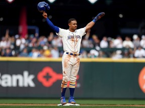 Julio Rodriguez #44 of the Seattle Mariners is acknowledged after stealing his 25th base and recording his 25th home run in a single rookie season during the fifth inning against the San Diego Padres at T-Mobile Park on September 14, 2022 in Seattle, Washington.