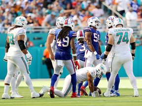 Tua Tagovailoa #1 of the Miami Dolphins down on the field after being sacked during the second half of the game against the Buffalo Bills at Hard Rock Stadium on September 25, 2022 in Miami Gardens, Florida.