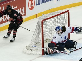 Canada's Marie-Philip Poulin scores on U.S. goalie Nicole Hensley during the overtime period of a women's exhibition hockey game billed as the Rivalry Rematch, Saturday, March 12, 2022, in Pittsburgh.