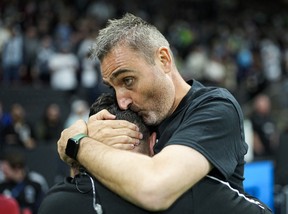Caps head coach Vanni Sartini embraces assistant coach Mike D’Agostino while celebrating after defeating the Seattle Sounders 2-1 at B.C. Place.