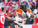 B.C. Lions James Butler runs the ball against the Calgary Stampeders during CFL football in Calgary on Saturday, Sept. 17, 2022.