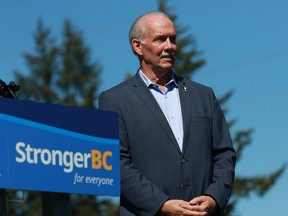 Premier John Horgan looks on during an announcement about financial aid due to inflation and the cost-of-living increases and support during a press conference at Goudy Field in Langford, B.C., on Wednesday, September 7, 2022.