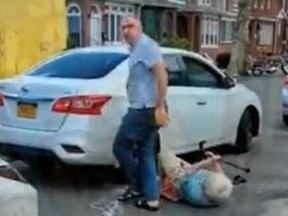 Taxi driver trying to rob elderly woman of phone after dragging her from his car.
