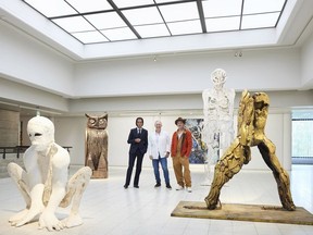 British artist Thomas Houseago, centre, poses with actor Brad Pitt, centre right and musician Nick Cave, prior to the opening of their joint exhibition, in Tampere, Finland, Saturday, Sept. 17, 2022.