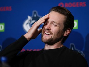Canucks star goalie Thatcher Demko laughs while considering a question during Wednesday's news conference in Vancouver, ahead of Thursday's opening of training camp.