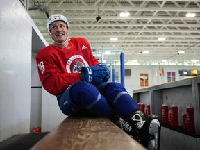 Rookie Canucks winger Andrei Kuzmenko smiles on the bench during the Canucks' first day of practice in Whistler on Thursday.