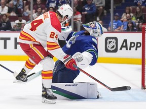 Flames forward Brett Ritchie takes a goalie-interference minor on Spencer Martin in the first period Sunday at Rogers Arena.