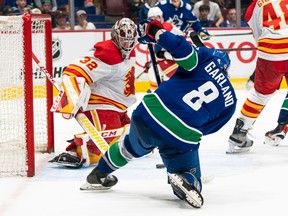Conor Garland scored late Sunday to get the Canucks to overtime in a 3-2 pre-season loss to the Flames at Rogers Arena.