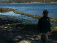 High tide rolls in as a Parks Canada employee looks over the clam bed restoration while on a Salish sea garden tour on Russell Island, a 32-acre Gulf Island National Park near in Salt Spring Island, B.C., Thursday, Sept. 8, 2022.