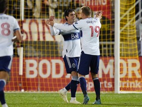 Vancouver Whitecaps forward Brian White (24) celebrates his goal with defender Julian Gressel (19) against the Colorado Rapids at Dick's Sporting Goods Park in Commerce City, Colo., on Sept. 10, 2022.