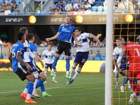 San Jose Earthquakes midfielder Jackson Yueill (14) heads the ball against /Vancouver Whitecaps forward Brian White (24) during the first half at PayPal Park.