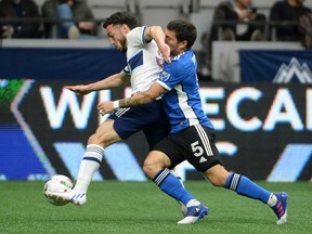 Vancouver Whitecaps forward Russell Teibert (31) blocks San Jose Earthquakes midfielder Eric Remedi (5) during the first half at B.C. Place.