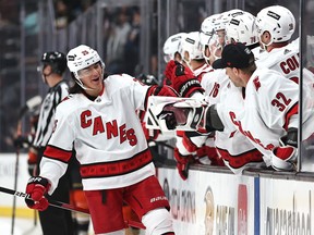 Ethan Bear (#25) of the Carolina Hurricanes celebrates at the bench after scoring a goal during the first period of a game against the Anaheim Ducks at Honda Center on Nov. 18, 2021 in Anaheim, California.
