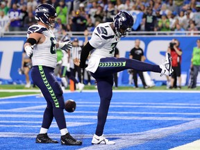 Geno Smith #7 of the Seattle Seahawks celebrates after scoring a touchdown during the first quarter of the game against the Detroit Lions at Ford Field on October 02, 2022 in Detroit, Michigan.