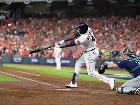 Yordan Alvarez #44 of the Houston Astros hits a two-run double against the Seattle Mariners during the third inning in game one of the American League Division Series at Minute Maid Park on October 11, 2022 in Houston, Texas.