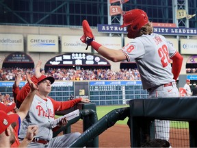 Alec Bohm #28 of the Philadelphia Phillies is congratulated by teammates in the dugout after scoring during the 9th inning of Game Two of the 2022 World Series against the Houston Astros at Minute Maid Park on October 29, 2022 in Houston, Texas.