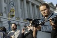 David DePape, right, records the nude wedding of Gypsy Taub outside City Hall on Dec. 19, 2013, in San Francisco.