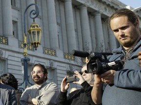 David DePape, right, records the nude wedding of Gypsy Taub outside City Hall on Dec. 19, 2013, in San Francisco.