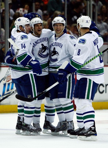 Alex Burrows #14, Kevin Bieksa #3, Jannik Hansen #36 and Willie Mitchell #8 of the Vancouver Canucks celebrate Bieksa's goal in the second period against the Anaheim Ducks looks at the Honda Center on October 31, 2008 in Anaheim, California.