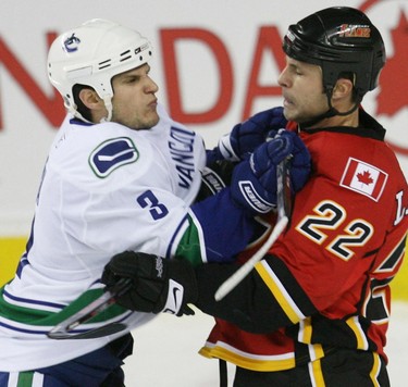 Vancouver Canucks' Kevin Bieksa and Daymond Langkow of the Calgary Flames during NHL hockey action in Calgary, November 29, 2008.