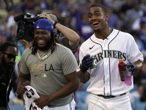 Blue Jays’ Vlad Guerrero Jr. (left) and Mariners’ Julio Rodriguez, sharing a laugh at the All-Star Home Run Derby in July, carry high expectations in this wild-card series for their respective teams.