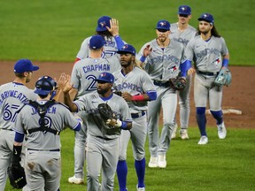 Blue Jays players celebrate a doubleheader sweep against the Orioles in Baltimore early last month. The Blue Jays head into the wild-card series having won 22 of their past 33 games since the start of September.
