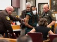 In this file photo taken Nov. 23, 2021, Darrell Brooks (centre) appears at Waukesha County Court in Waukesha, Wis.