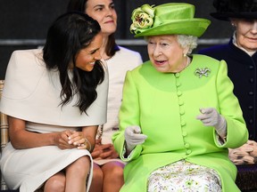 Queen Elizabeth II sitts and laughs with Meghan, Duchess of Sussex during a ceremony to open the new Mersey Gateway Bridge on June 14, 2018 in the town of Widnes in Halton, Cheshire, England.