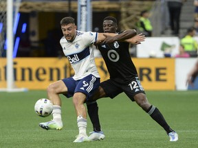 Vancouver Whitecaps FC forward Lucas Cavallini (9) challenges Minnesota United FC defender Bakaye Dibassy (12) during the at B.C. Place. Photo: Anne-Marie Sorvin-USA Today Sports